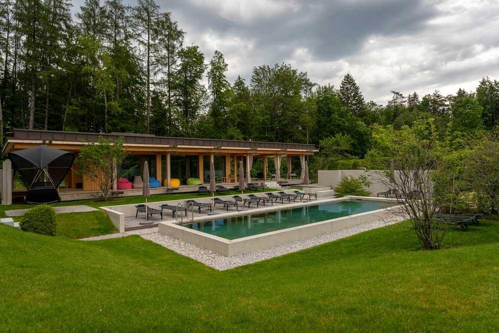 Large biopool in the hotel garden with loungers and modern architecture