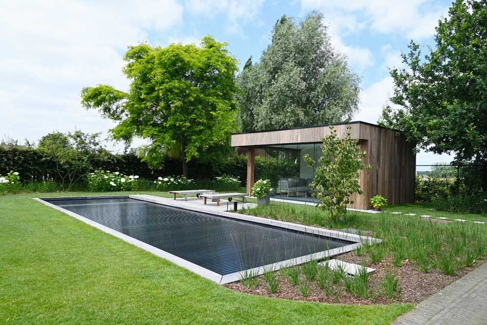 Biotop Living Pool with modern terrace and poolhouse in a stylish garden