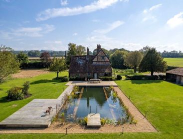 Rectangular natural pond from Biotop behind an old farmhouse