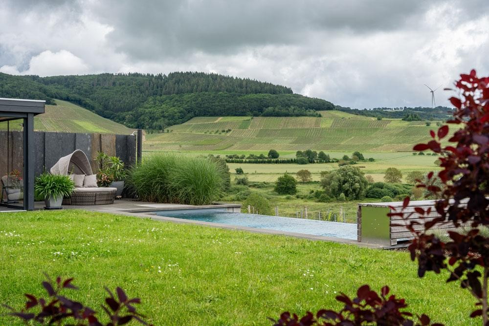 Natural pool in the garden with unobstructed views over rolling hills