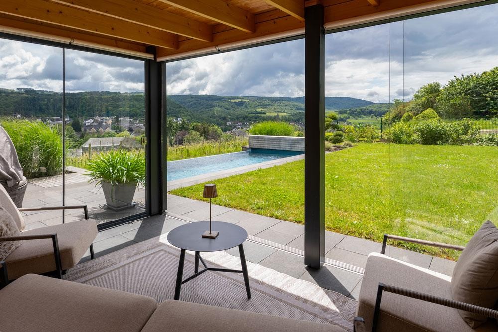 View from the living space to the natural pool and expansive landscape