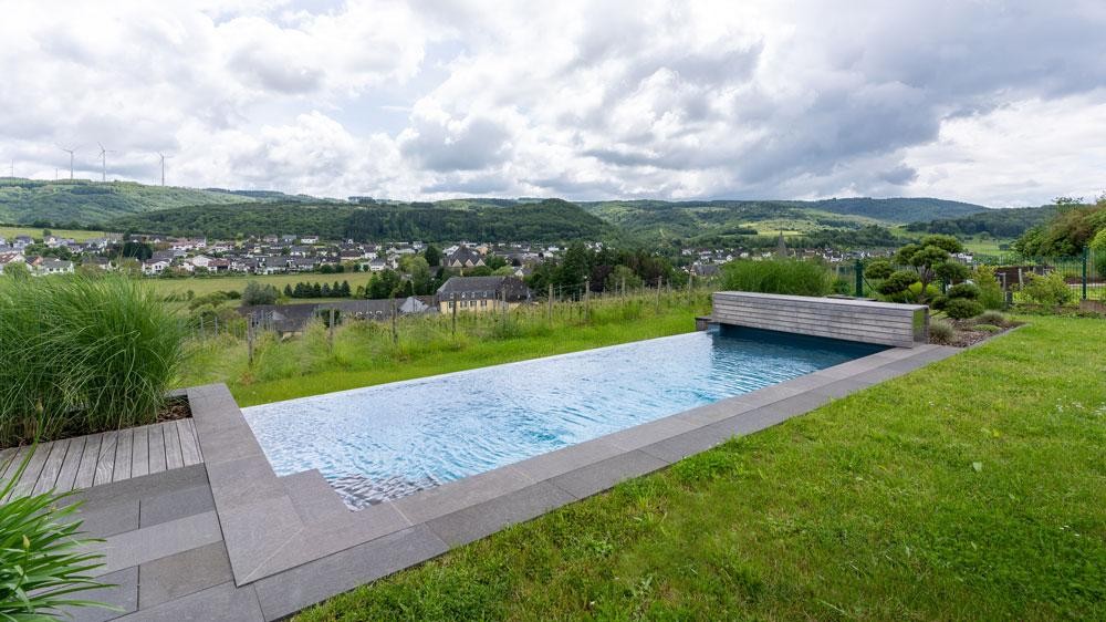 Natural pool on a slope with far-reaching views over the landscape and village