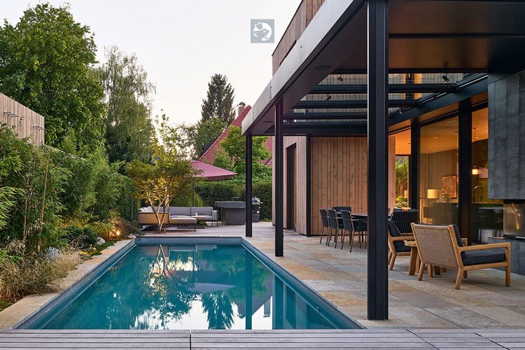 Inviting natural pool with terrace extends the living space in the city