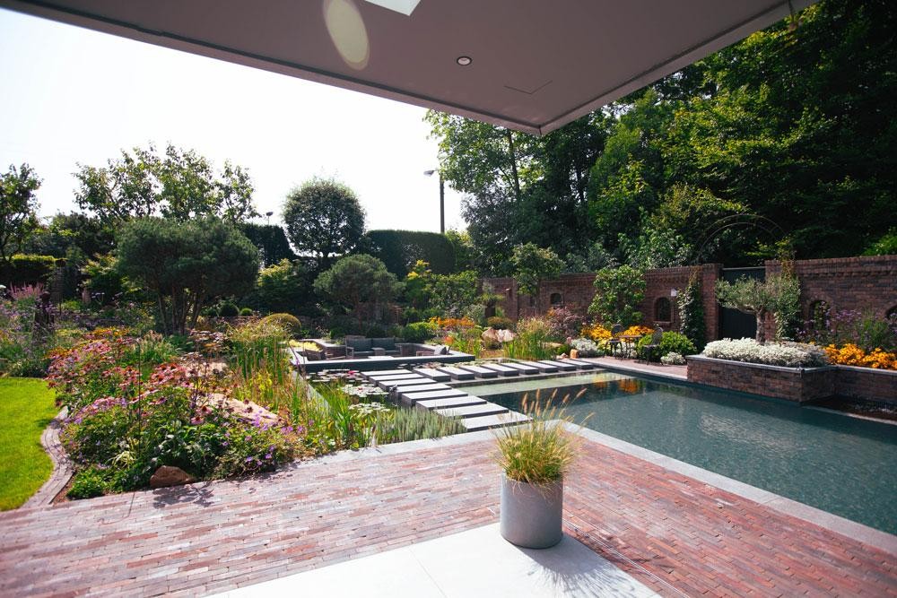 Natural pool with terrace water lilies and natural planting