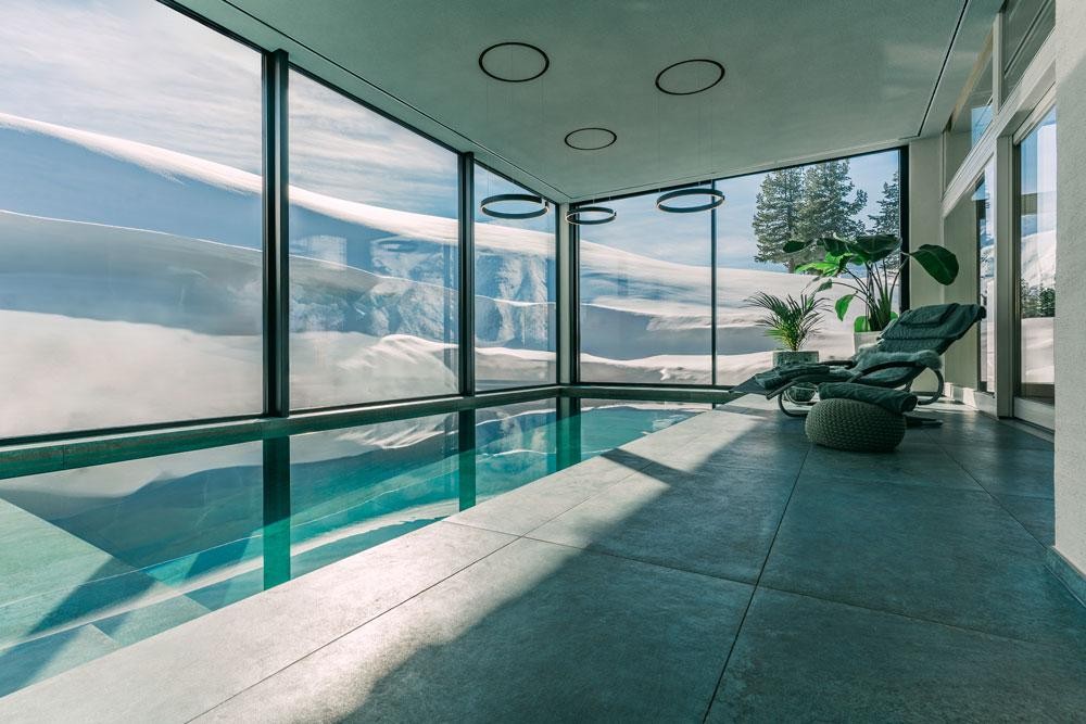 Bright Indoor Living Pool with glass front and snowy landscape