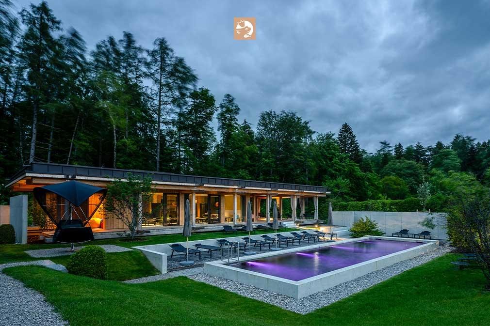 Biopool at a hotel in the evening with lighting and forest backdrop