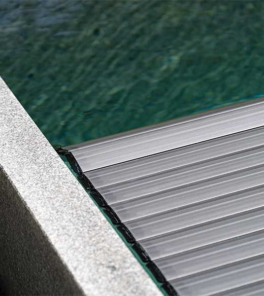 Detail of a pool cover that floats on the water in a granite pool