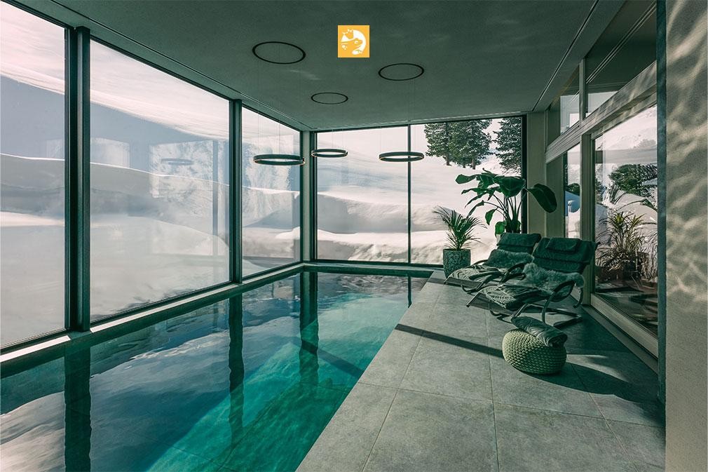 Indoor Living Pool with mountain view and loungers in wellness room