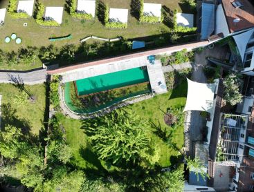 Natural pool from above with timber deck and natural garden