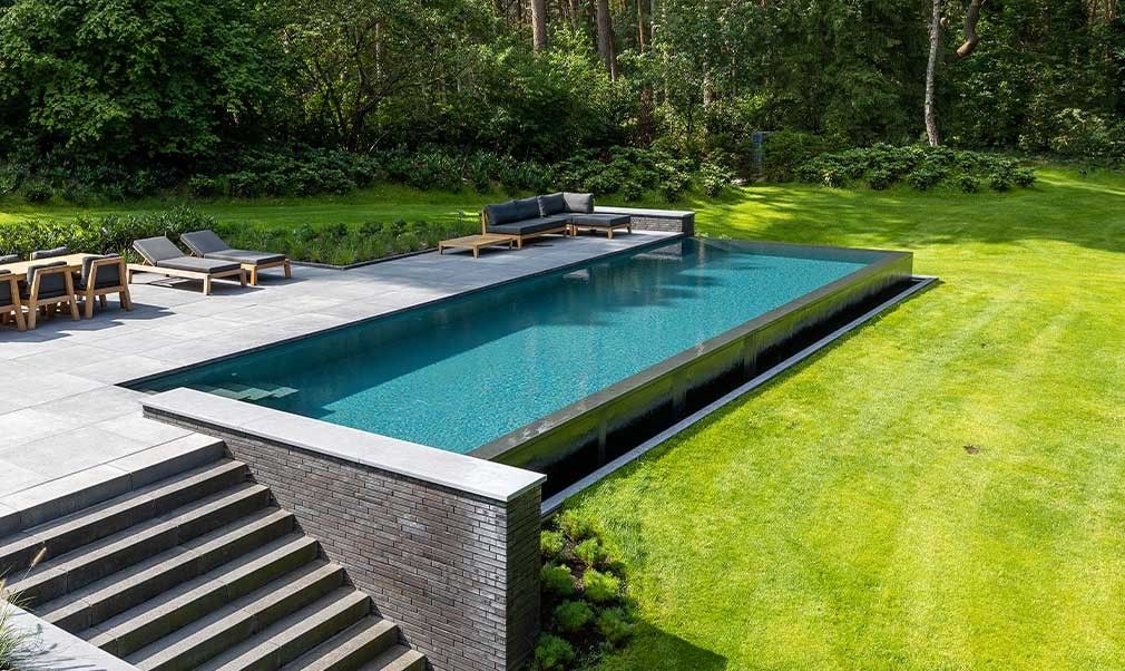 Natural pool in dark grey finish from Biotop with infinity edge