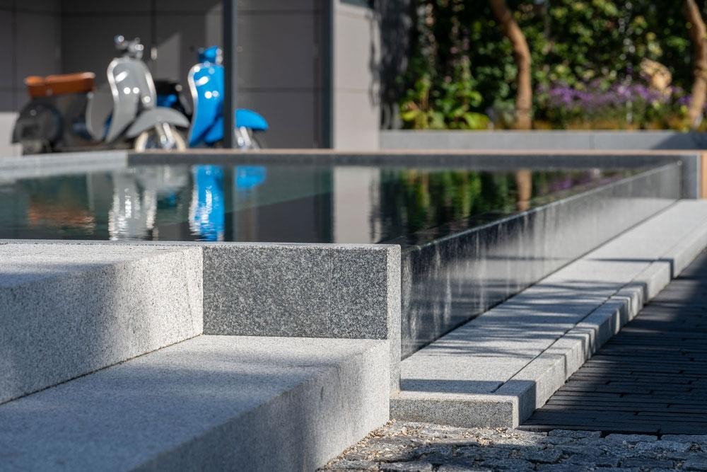 Close-up of a natural pool with Kusser granite edge and steps