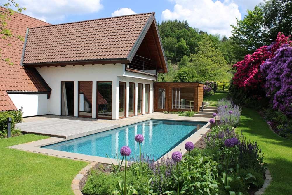 Natural pool with rhododendrons and blooming garden