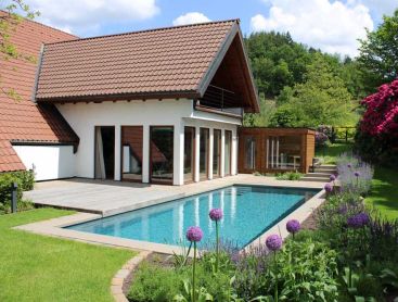 Natural pool with rhododendrons and blooming garden