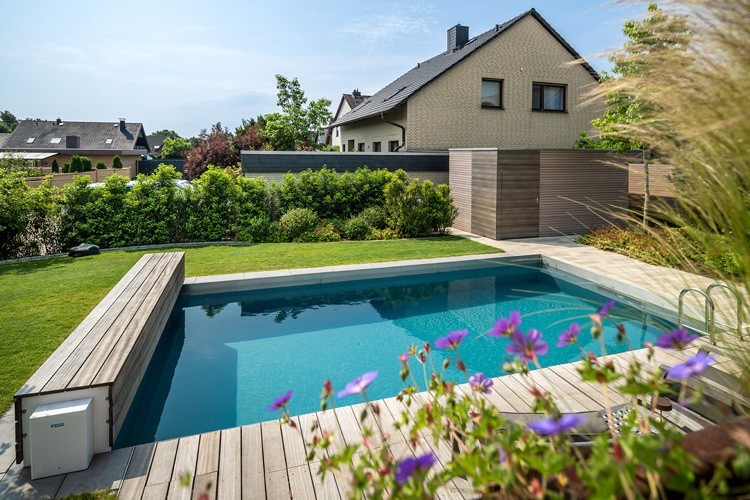 Natural pool in the green with a wooden pool cover