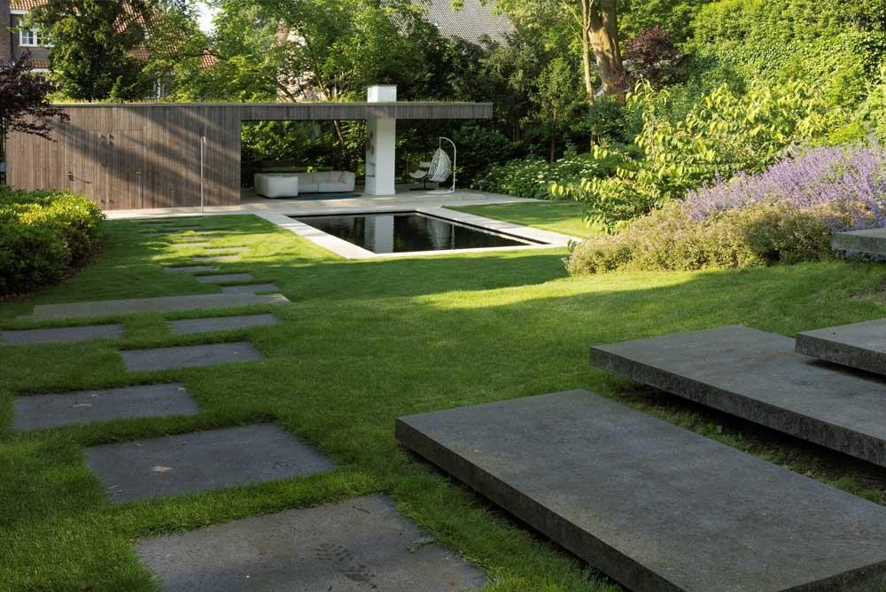 Natural pool with terrace, lawn and flowering garden design