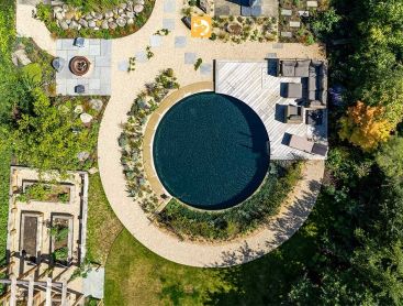 Aerial view of a round Swimming Pond with diverse planting and wooden terrace