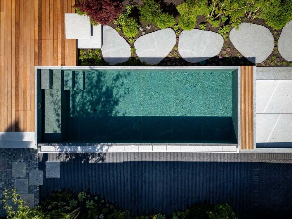 Schleitzer natural pool from a birds eye view with wooden deck