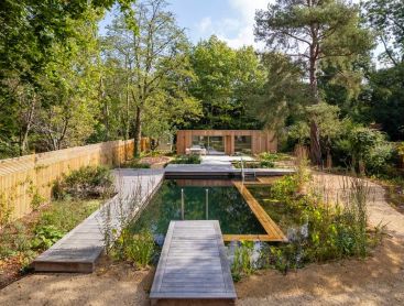 Surrounded by large trees this Swimming Pond becomes the centrepiece of the garden